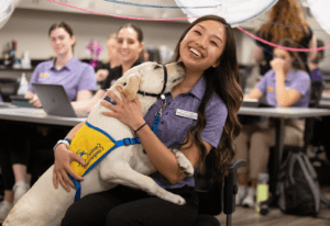 Health student posing with Canine Companion puppy